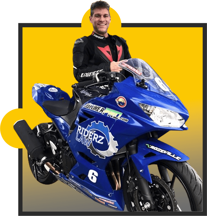 A man sitting on top of a blue motorcycle.
